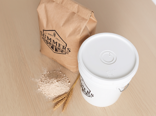 Summers Grains 20 lb bag side angle showing name with storage bucket